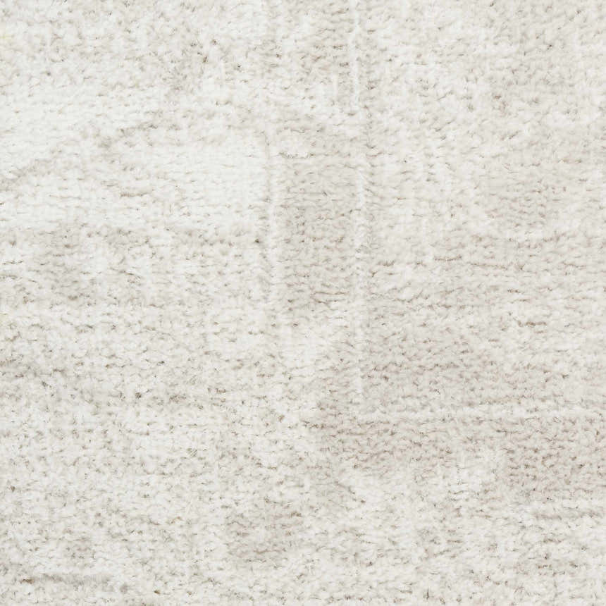 Close-up of the high pile, light grey Nourison Dekor vintage rug, showing texture and subtle pattern.
