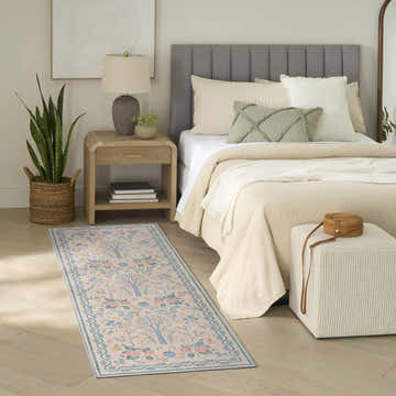 Bedroom scene with Nourison Botanical Ivory Multicolor rug, neutral tones, and mid-century modern decor.