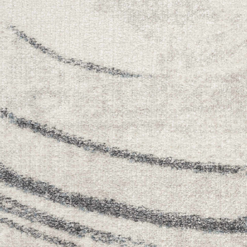 Close-up of the Nourison Astra Silver Blue Rug. Features a wavy, modern design in shades of gray and blue. Soft texture.