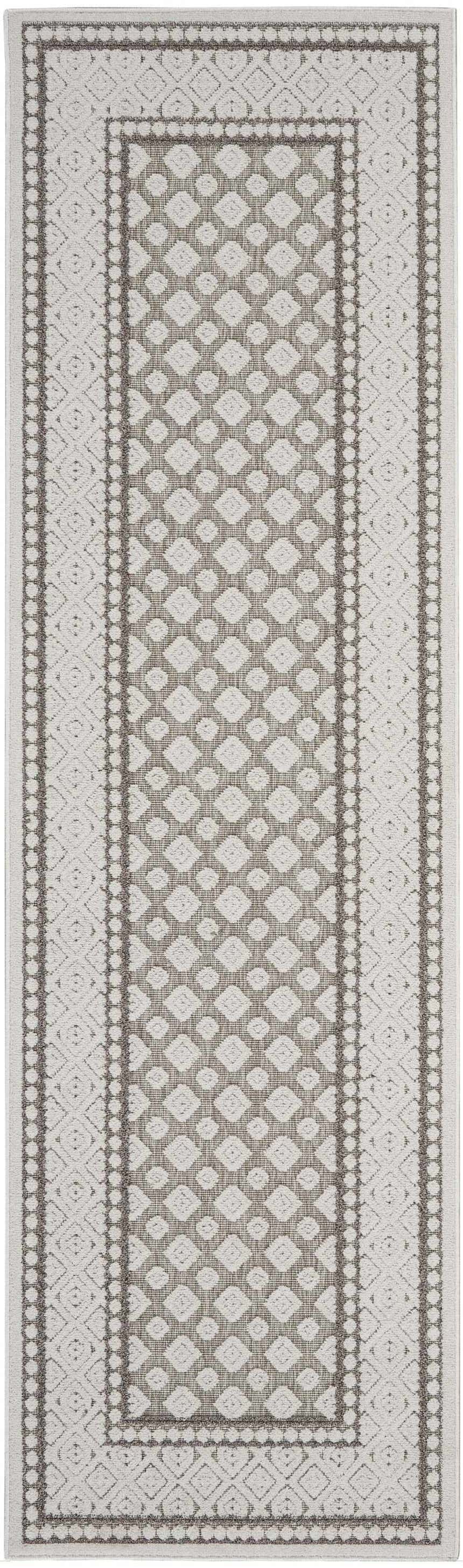 Close-up of the Nourison Key Largo Light Grey rug, featuring a geometric diamond pattern and farmhouse style border.