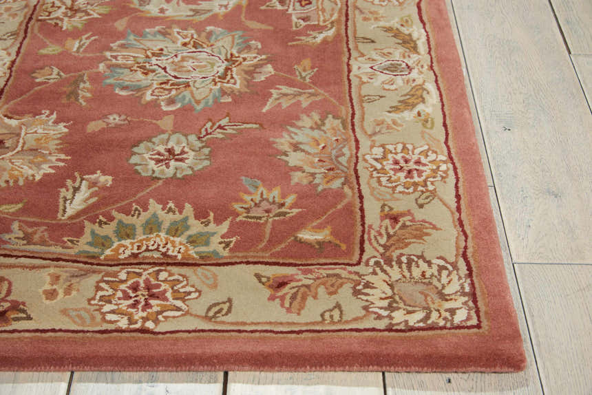 Close up of the floral design on the Nourison 2000 Rose Persian rug. Handmade wool rug with pink, beige, and blue accents.