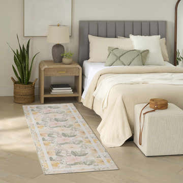 Farmhouse bedroom scene with Nourison Botanical Ivory rug, wood floors, and neutral decor.