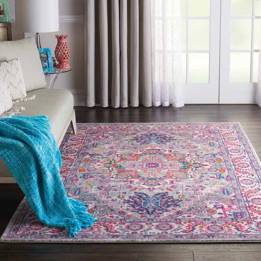 Living room with a Nourison Passion Light Grey Pink Bohemian Indoor Area Rug.