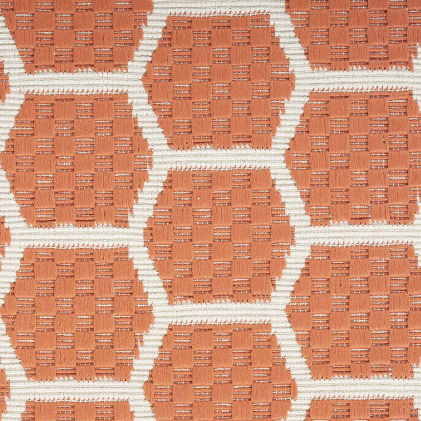 Close-up of Nourison Twist Reversible Coral rug, featuring a geometric, textured weave in coral and white.