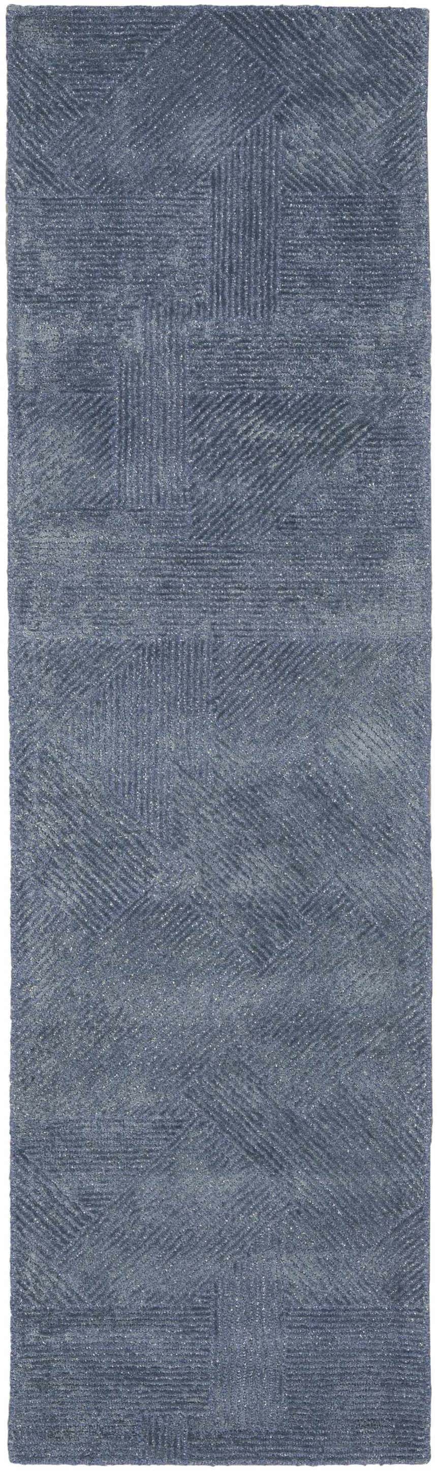 Close-up of the handmade Michael Amini MA30 Star Blue rug. The modern rug features a geometric pattern and wool/rayon blend.