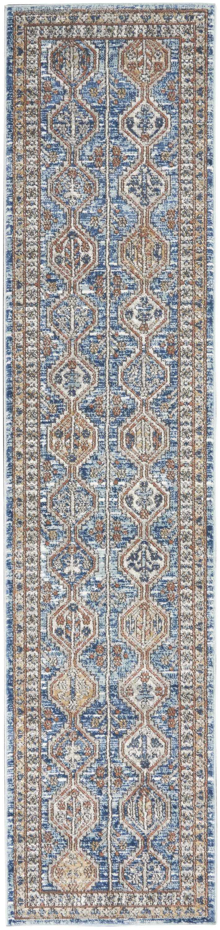 Close-up of Nourison Quarry Blue Multicolor rug. Contemporary design with blue, brown, and ivory geometric patterns.