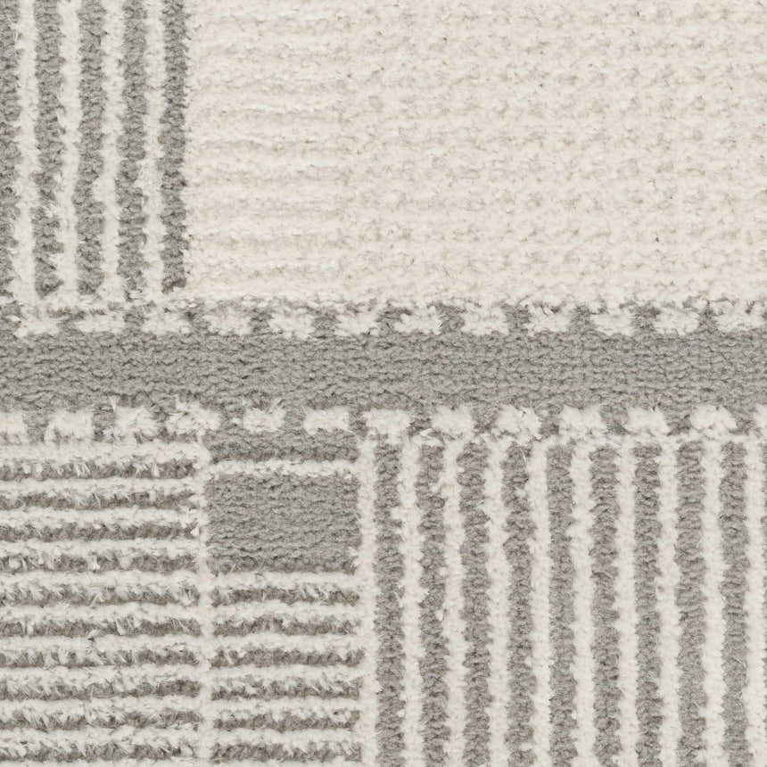Close-up of the Nourison Nordic Ivory Grey rug showing its pile texture and mid-century modern geometric pattern.