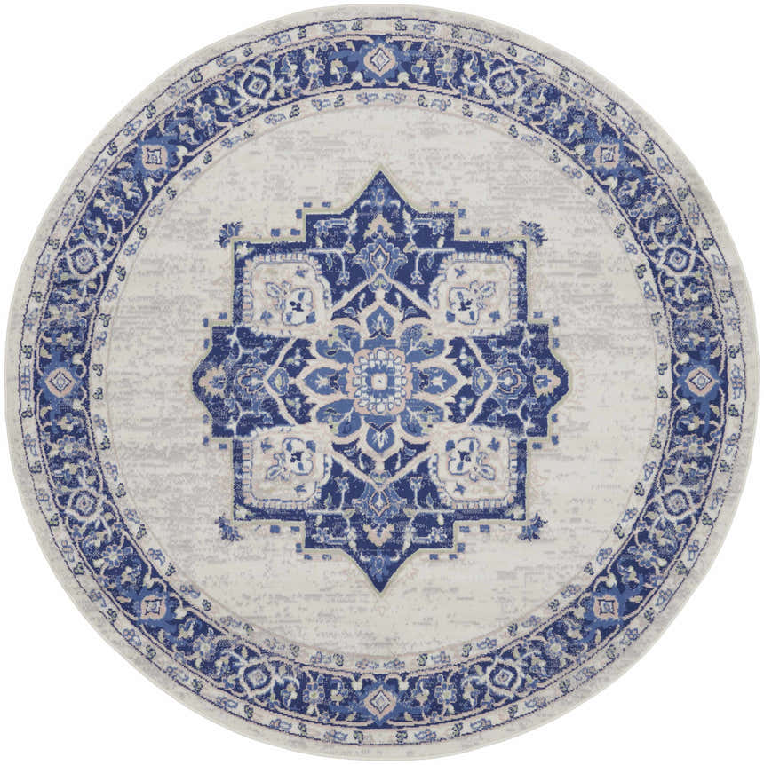Round Nourison Whimsicle Ivory Blue rug. Farmhouse style rug with a blue medallion pattern on an ivory background.