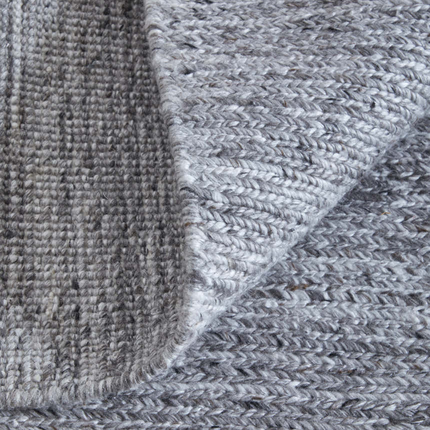 Close-up of the hand-knotted Feizy Finley Gray/Ivory rug showing its chunky, textured weave and neutral color palette. Fold