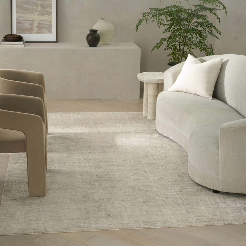 Modern living room with neutral furniture and Calvin Klein CK090 Latitude Ivory Beige area rug.