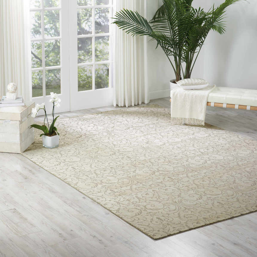 Bright living room with Nourison Luminance Opal Vintage Area Rug, white bench, and potted plant.