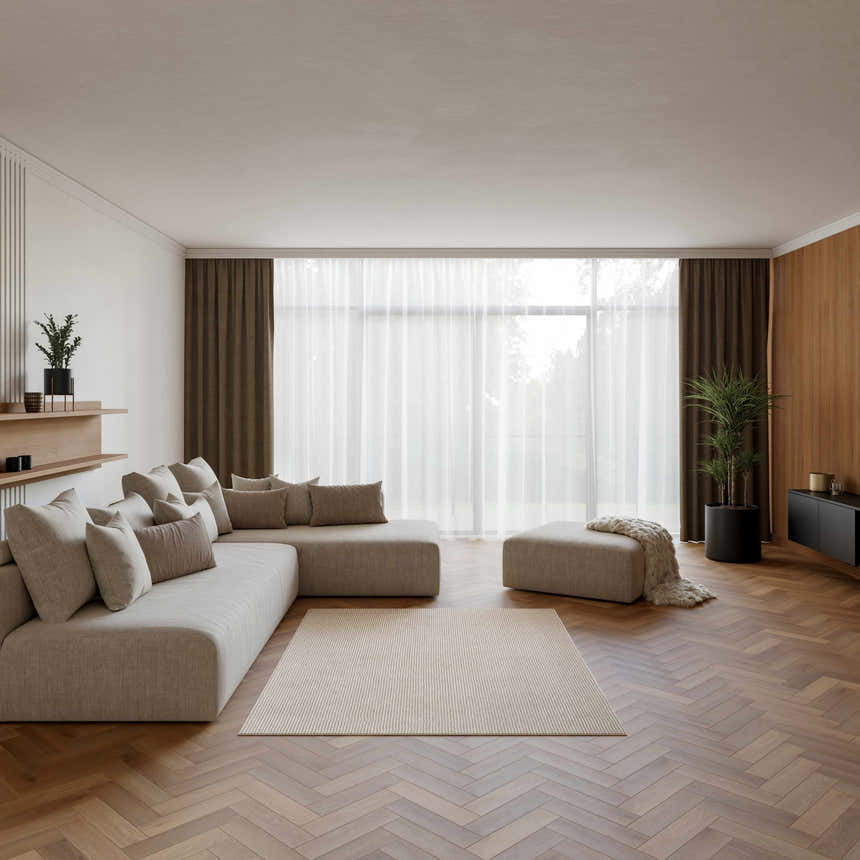 Living room with a beige sectional, wood floors, and Nourison Natural Texture Ivory Mocha rug.