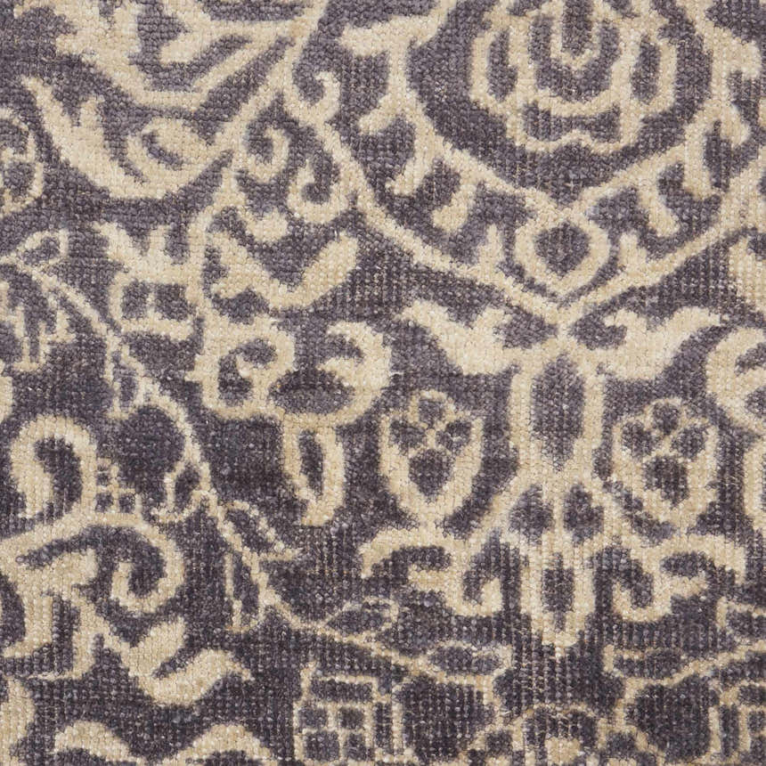 Close-up of the Nourison Aldora Royal Vintage rug. Features a detailed royal and beige floral pattern and silk-like fiber texture.