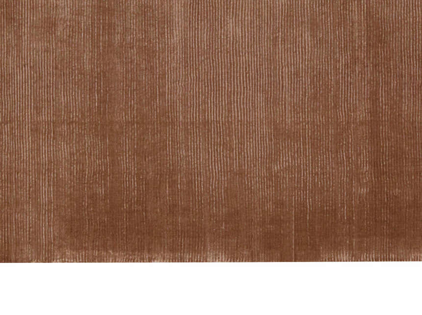 Close-up of the Calvin Klein Home Lunar Foal rug in foal. Features a subtle vertical line pattern and soft, plush texture.
