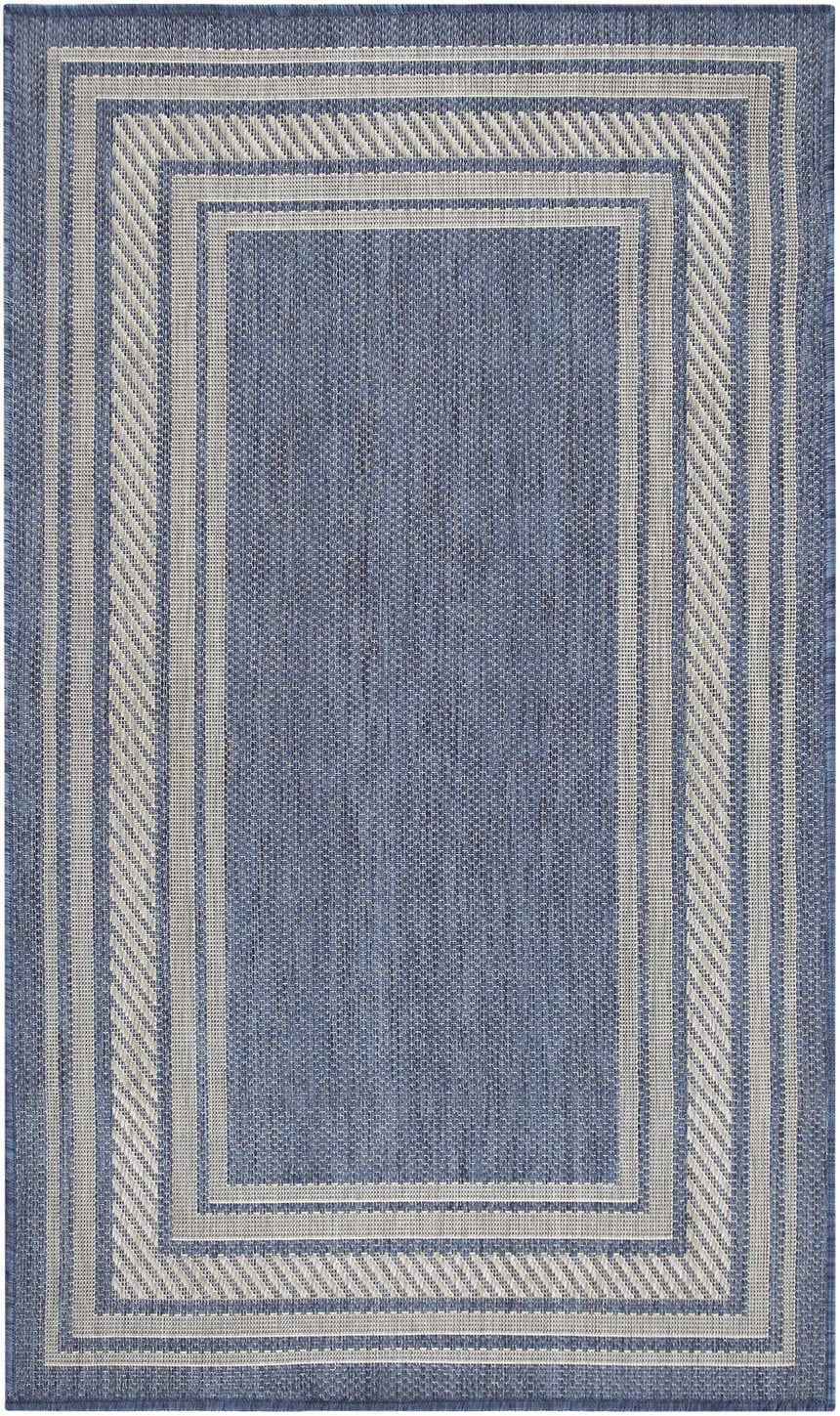 Close-up of the Nourison Horizon Denim Area Rug. Features a blue woven texture and a gray geometric border.