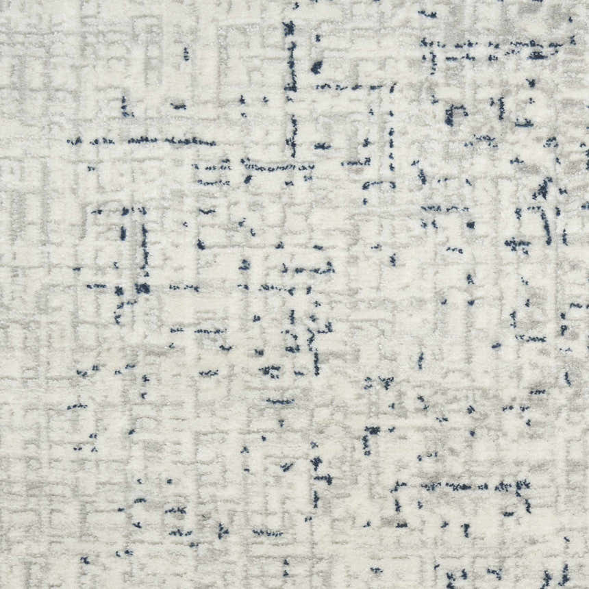 Close-up of the DKNY Grand Street Ivory Blue rug showing its abstract grid pattern and soft pile texture.