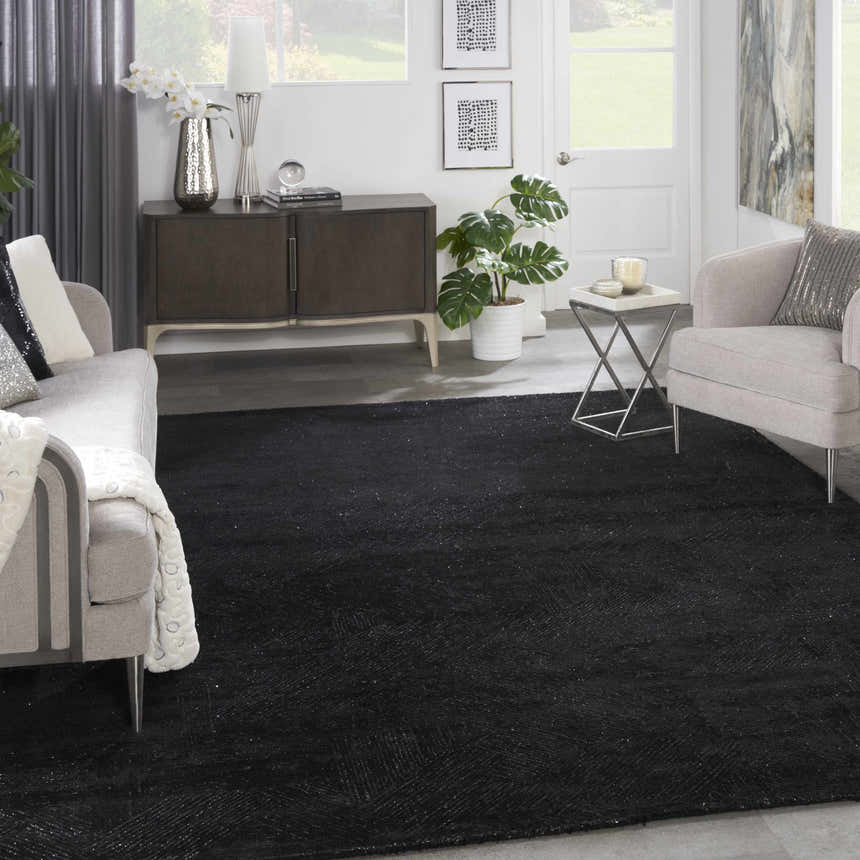 Modern living room with a black Michael Amini MA30 Star area rug, gray sofa, and accent chair.