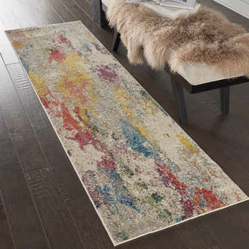 Hallway scene with Nourison Celestial Ivory Multicolor rug, bench with fur throw, and dark wood floors.