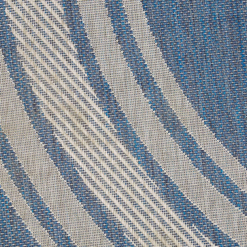 Close-up of the Nourison Horizon Denim Area Rug. Features a blue and white striped pattern.