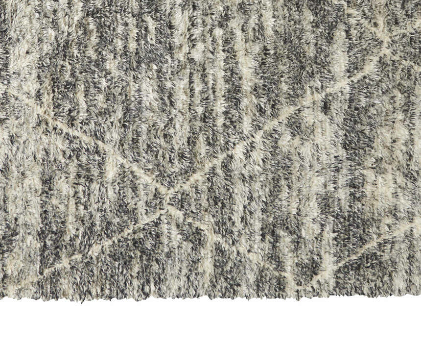 Close-up of the shaggy Calvin Klein San Antonio Charcoal Ivory rug. Wool texture with Moroccan-inspired design.