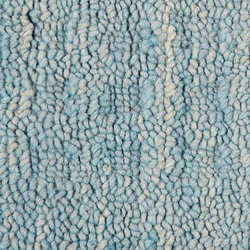 Close-up of the textured, hand-made Nourison Marana Sky Blue rug. Wool and cotton rug with a looped pile.