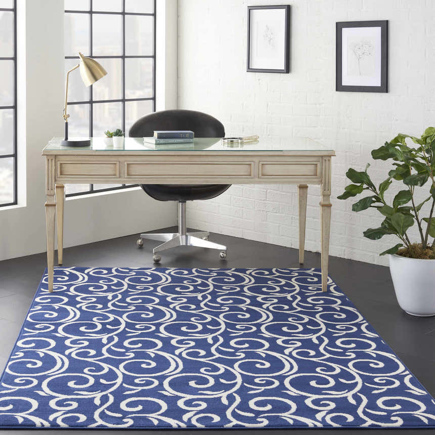 Home office with Nourison Grafix Navy rug, white walls, desk, and modern decor. Contemporary style.