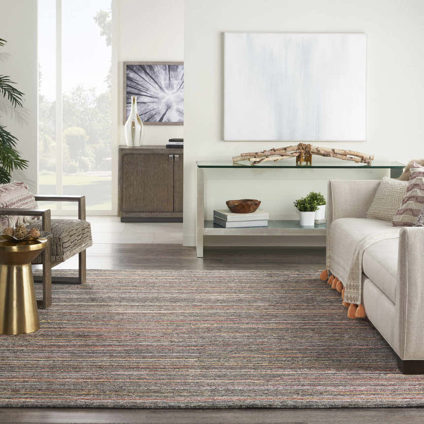 Living room scene with a Nourison Plateau Grey Flame rug, beige sofa, and mid-century modern decor.