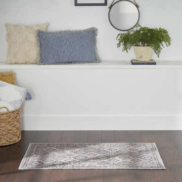 Bathroom scene with Nourison New Concept Ivory Latte Vintage rug. Chestnut and ivory tones, vintage style, on dark wood floor.