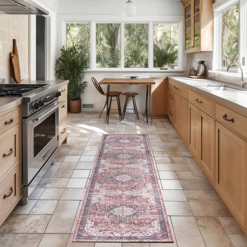 Red Vintage Indoor Washable Area Rug runner in a bright kitchen with wood cabinets and tile floor.