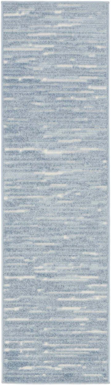 Close-up of Nourison Care Free Blue rug. Light blue with subtle horizontal stripe pattern. Mid-Century Modern style.