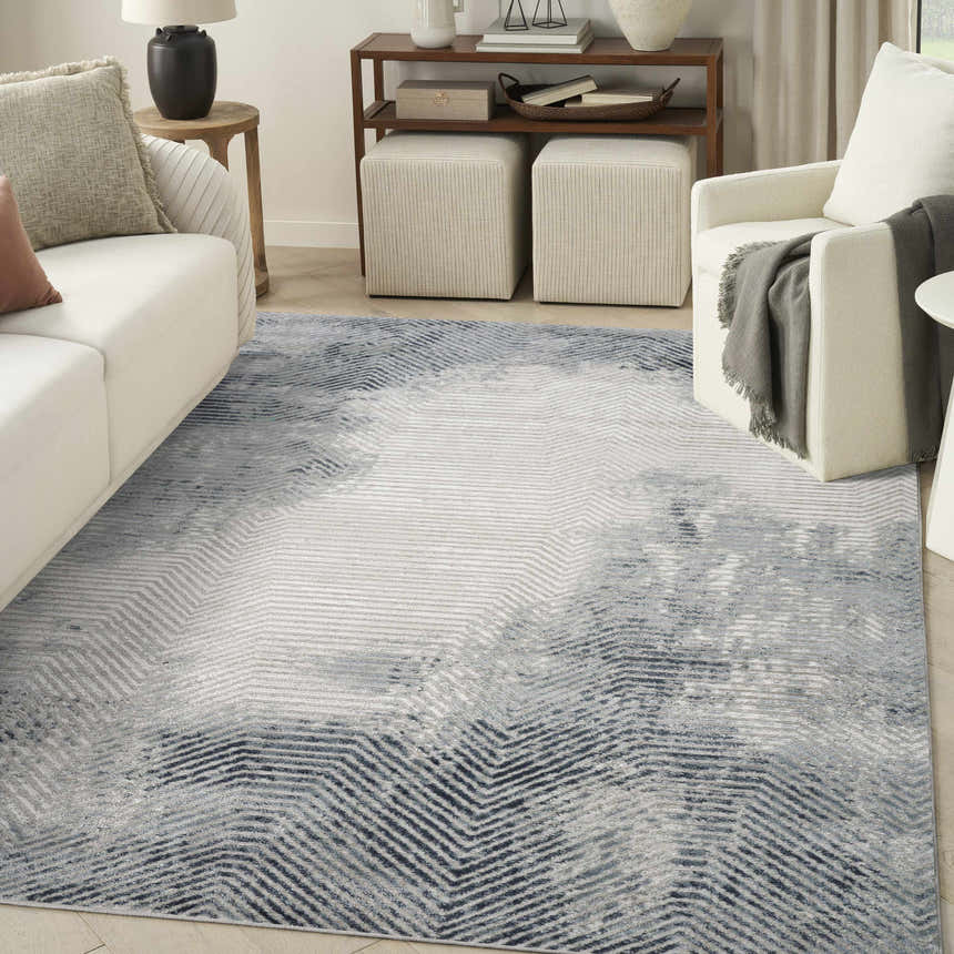 Modern living room with white sofa and Nourison Dekor Grey Navy Area Rug with geometric pattern.
