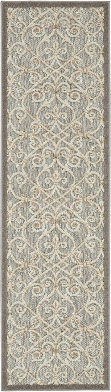 Close-up of the Nourison Aloha Natural Contemporary Area Rug featuring a cream floral pattern on a gray background.