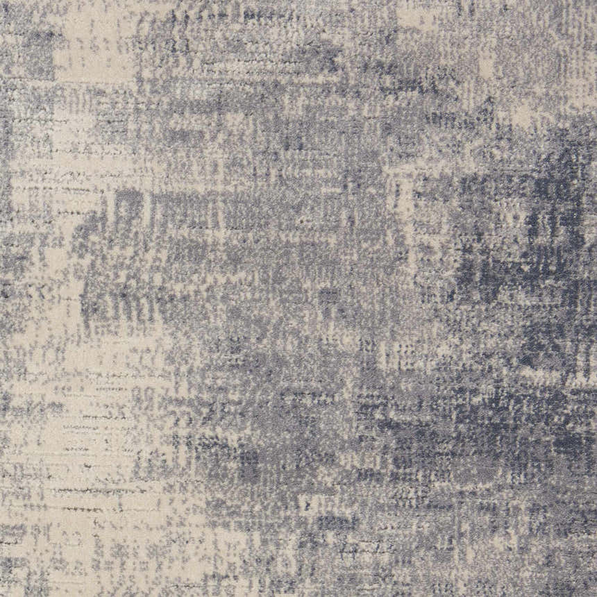 Close-up of the Nourison Rustic Textures Blue Ivory area rug, showcasing its distressed, mid-century modern design.