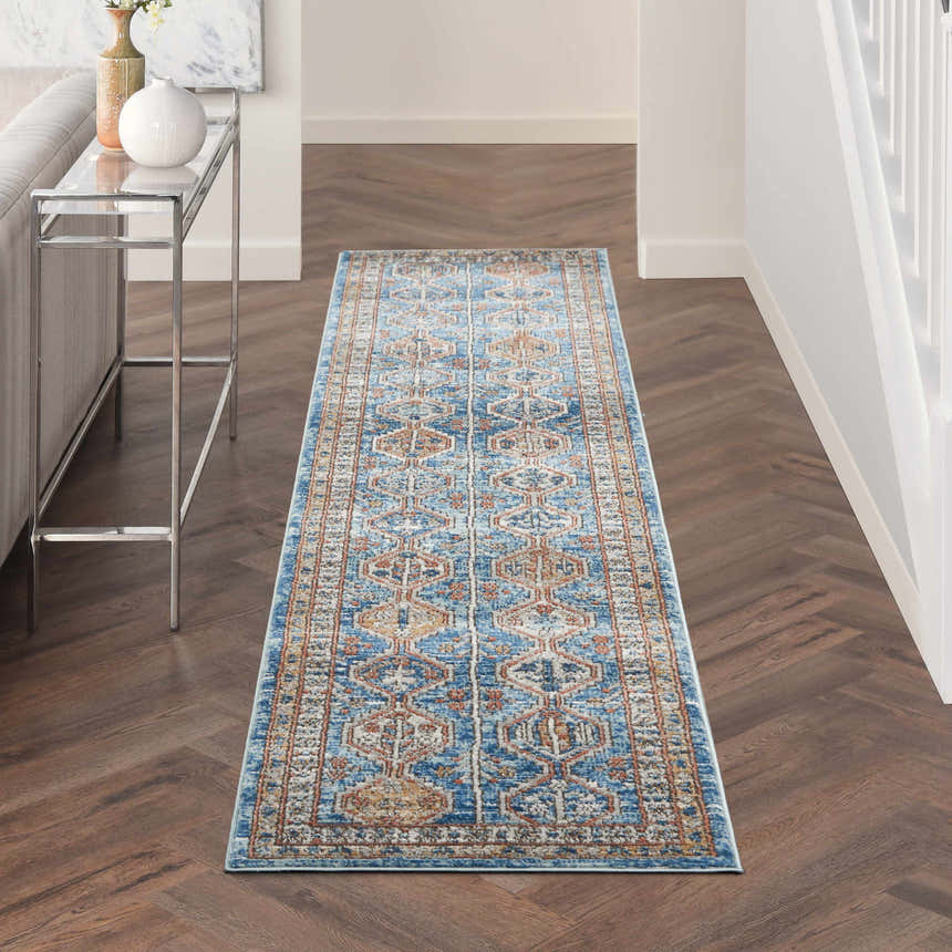 Hallway with Nourison Quarry Blue Multicolor runner rug, wood floors, console table, and neutral decor.