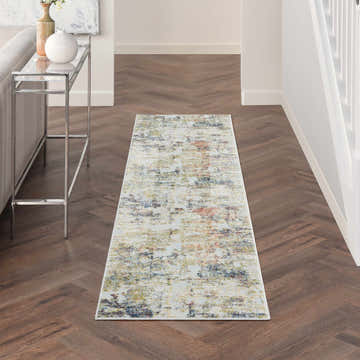 Hallway scene with Nourison Trance Ivory Multicolor rug, wood floors, console table, and neutral decor. Modern style.