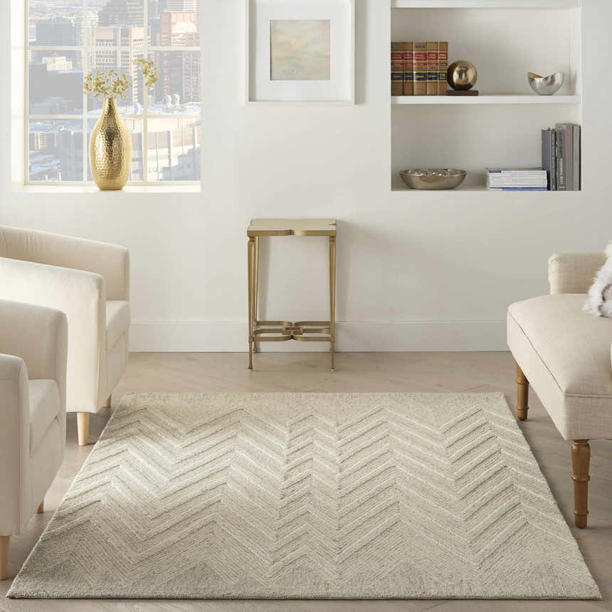 Bright living room with ivory chairs and Nourison Interlock Ivory/Grey rug featuring a modern chevron pattern.
