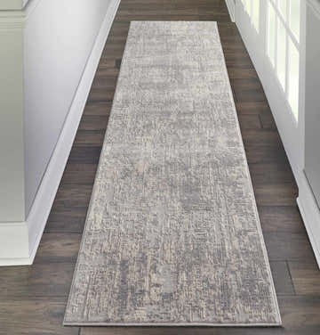 Hallway with a Nourison Rustic Textures Ivory/Silver rug runner on dark wood floors, white trim and doors.