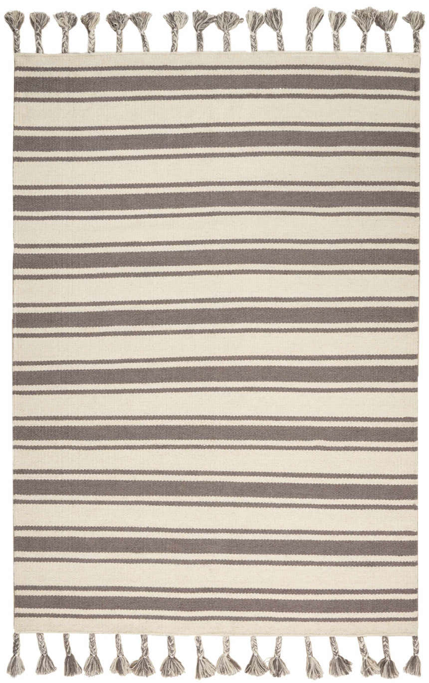 Close-up of Nourison Rio Vista Ivory/Grey rug. Bohemian style, handmade wool rug with chestnut brown stripes and tassels.