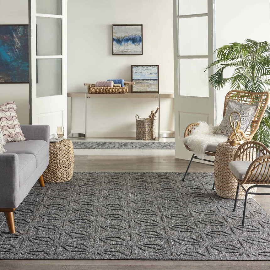 Living room scene with gray sofa and Nourison Cozumel Dark Grey rug, mid-century modern style.