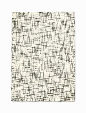 Close-up of Calvin Klein Tucson Ivory/Grey rug. Handmade wool rug with a modern, abstract grid pattern.