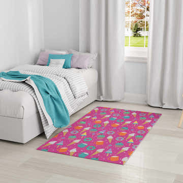 Kids room with the Nourison Imagination Pink Multicolor rug featuring a fun dessert pattern.