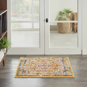 Entryway with Nourison Passion Ivory Yellow Bohemian Indoor Area Rug, wood floors, and white doors.