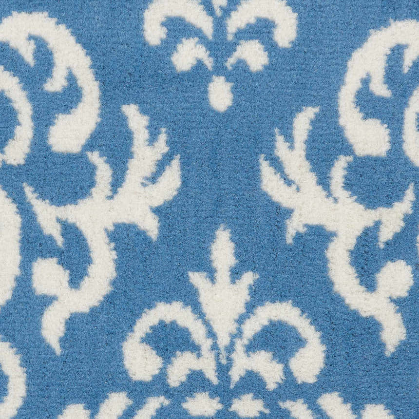 Close up of the Nourison Grafix Blue Vintage Indoor Area Rug showing the white damask pattern.