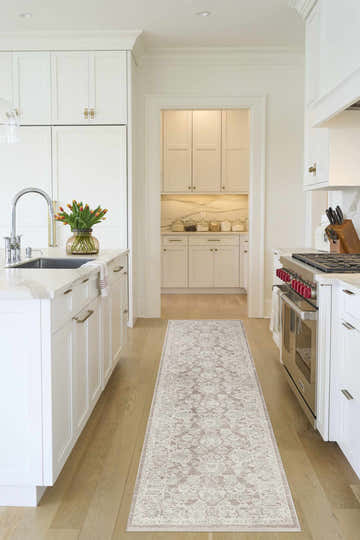 Bright kitchen scene with a Nourison Shadows Ivory Mocha Vintage runner rug on wood floors.