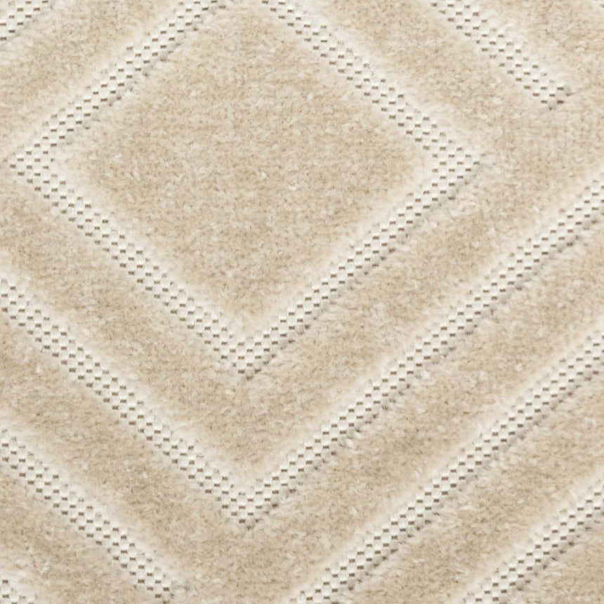 Close-up of the beige Nourison Care Free rug featuring a geometric diamond pattern and soft, textured pile.