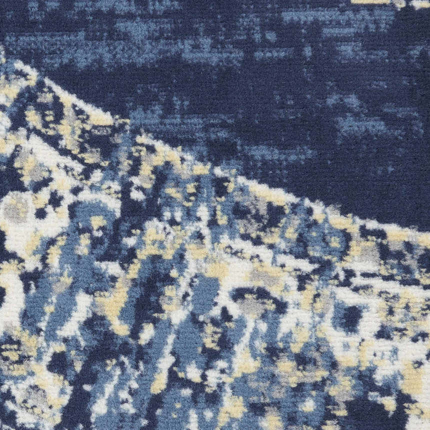 Close-up of the Nourison Grafix Navy Blue Vintage Area Rug showing texture and pattern details. Navy, blue, and cream colors.