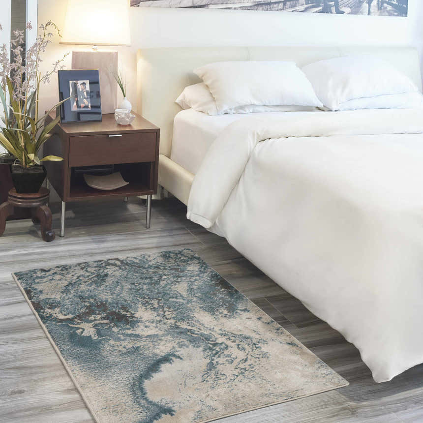 Modern bedroom with Nourison Maxell Ivory/Teal rug, white bedding, and wood nightstand.