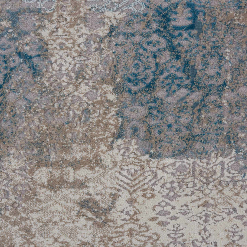 Close-up of Nourison Karma Ivory/Light Blue rug. Vintage style with chestnut, ivory, and blue tones. Machine-made texture.