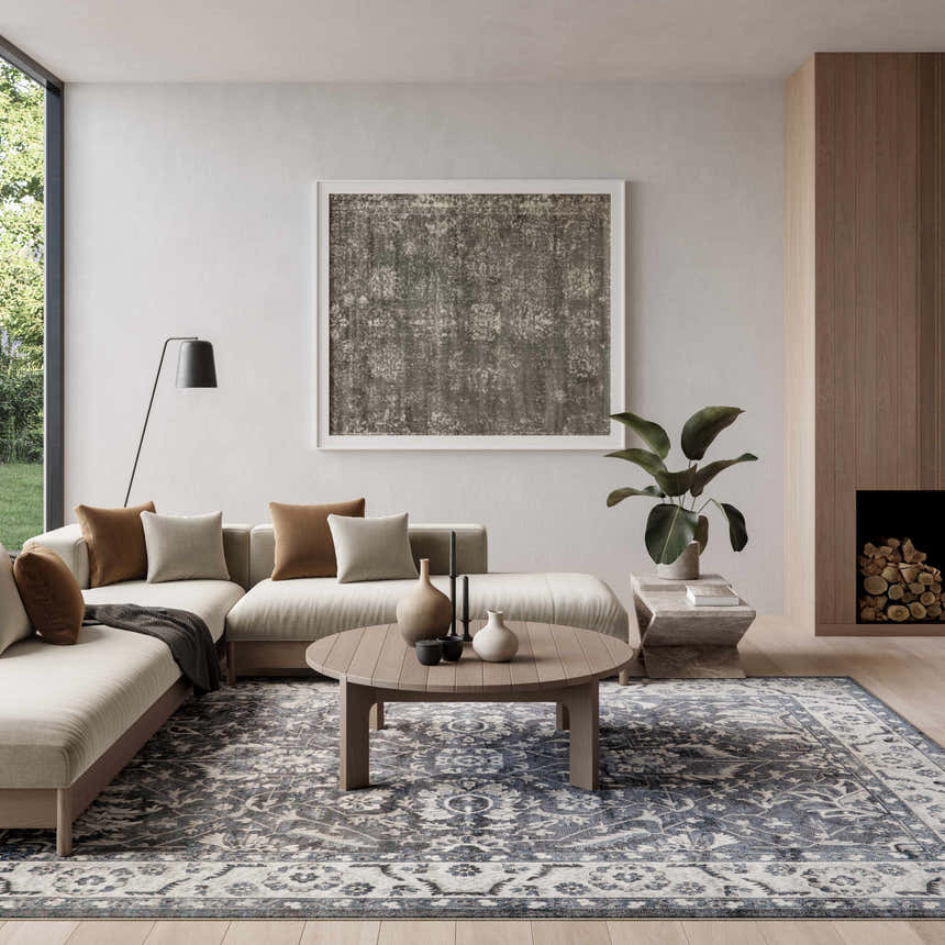 Living room with a neutral sofa and Nourison Astra Slate Vintage Area Rug in blue and taupe.
