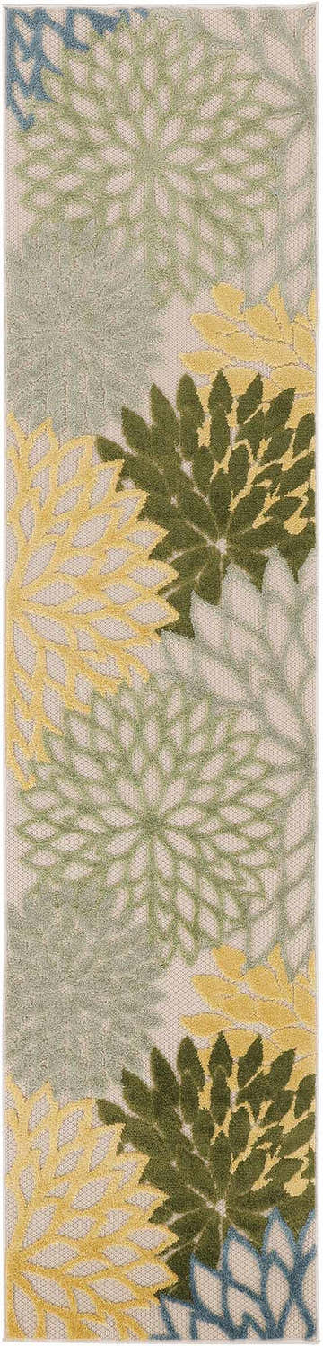 Close-up of Nourison Aloha Green Multicolor Tropical Area Rug with a leafy floral pattern in green, yellow, and blue.